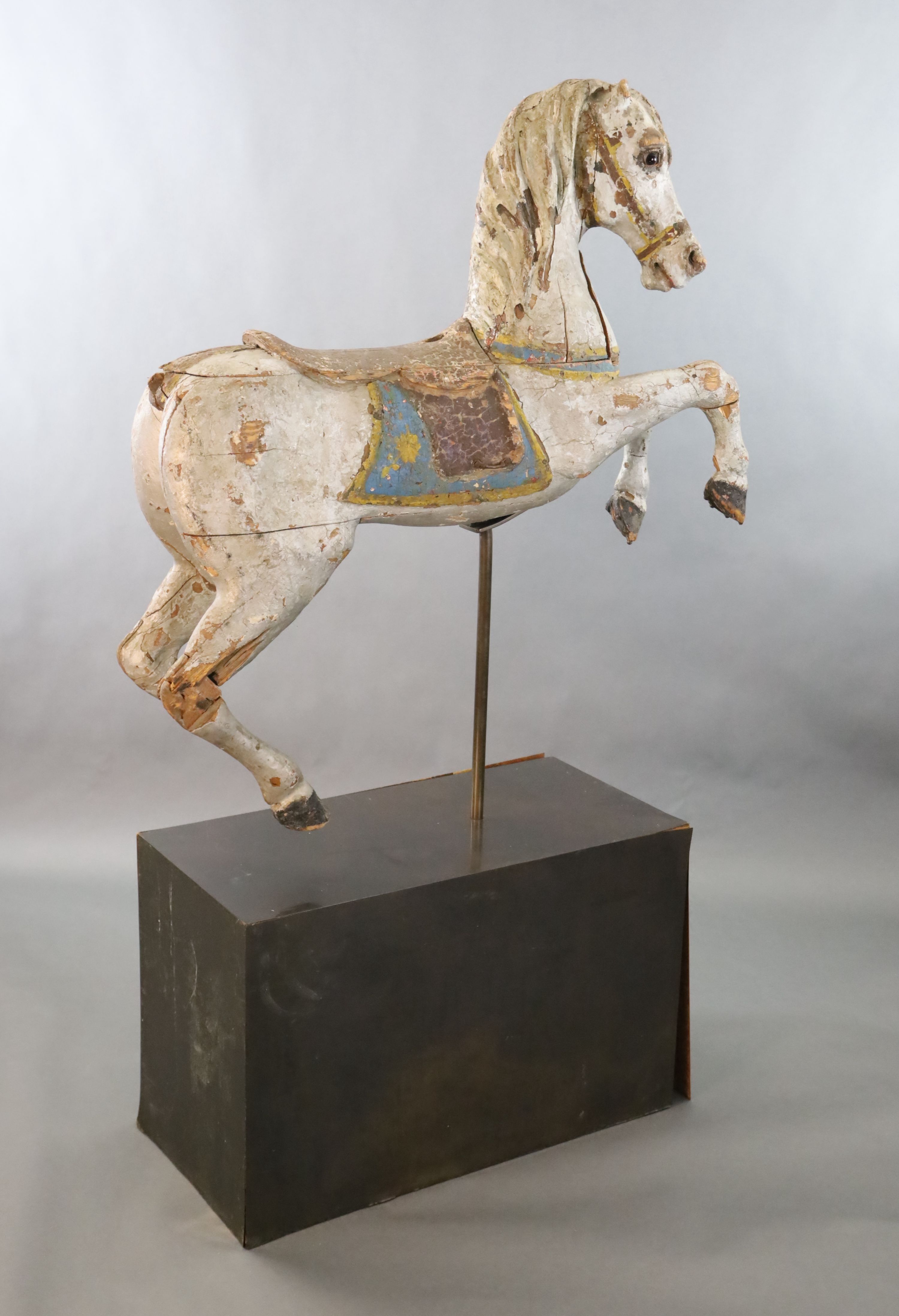 A 19th century, probably American, painted wood carousel horse, L.3ft 5in. H.3ft 7in. Overall H. when on stand 5ft 9in.